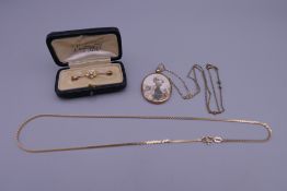 An unmarked gold and seed pearl brooch (1.6 grammes total weight), a 9 ct gold necklace (3.