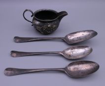 Three early silver spoons and a silver jug. 210.4 grammes.