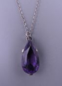 A silver amethyst pendant on chain. The pendant 2.25 cm high.