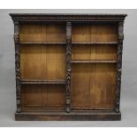 A Victorian carved oak open bookcase.
