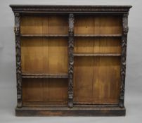 A Victorian carved oak open bookcase.