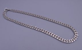An unmarked silver curb link necklace. Approximately 44 cm long. 82 grammes.