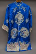 A Chinese embroidered silk robe.