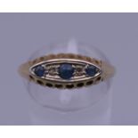 An 18 ct gold diamond and sapphire ring. Ring size Q. 2 grammes total weight.