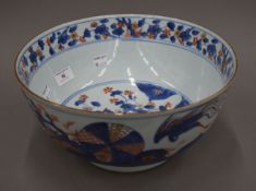 A large 18th century Chinese porcelain underglaze blue and iron red decoration punch bowl,