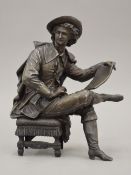 A 19th century patinated spelter model of a seated scholar. 23.5 cm high.