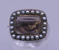 A 19th century natural seed pearl mounted mourning brooch. 1.5 cm wide.