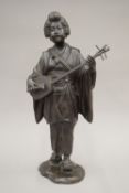 A Meiji Period Japanese patinated bronze model of a female musician. 42 cm high.