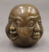 A brass four-face Buddha. 13.5 cm high.