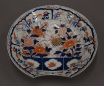 A 19th century Imari porcelain barber's bowl. 27 cm diameter.