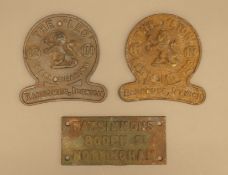 A Wat Simmons and two Ransomes lawn mower iron plaques. The former 15 cm wide.