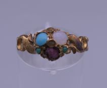 An unmarked gold gem set ring. Ring size L/M.