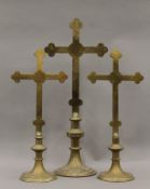 A set of three brass altar piece crosses. The largest 75 cm high.