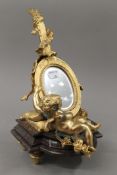 A gilt bronze cherub lyre mirror. 30 cm high.