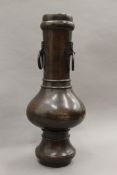 A Chinese patinated bronze vase with ring handles. 39 cm high.