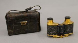 A pair of Zeiss snakeskin mounted cased opera glasses. The case 11 cm wide.