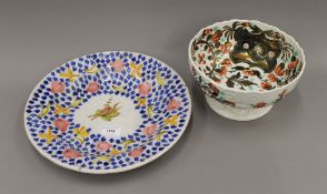 A coloured Delft dish and a porcelain bowl. The former 34.5 cm diameter.