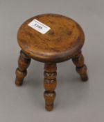 A miniature treen stool. 13 cm high.