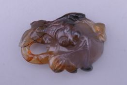 An agate pendant carved with lily pad and goldfish. 5 cm high.