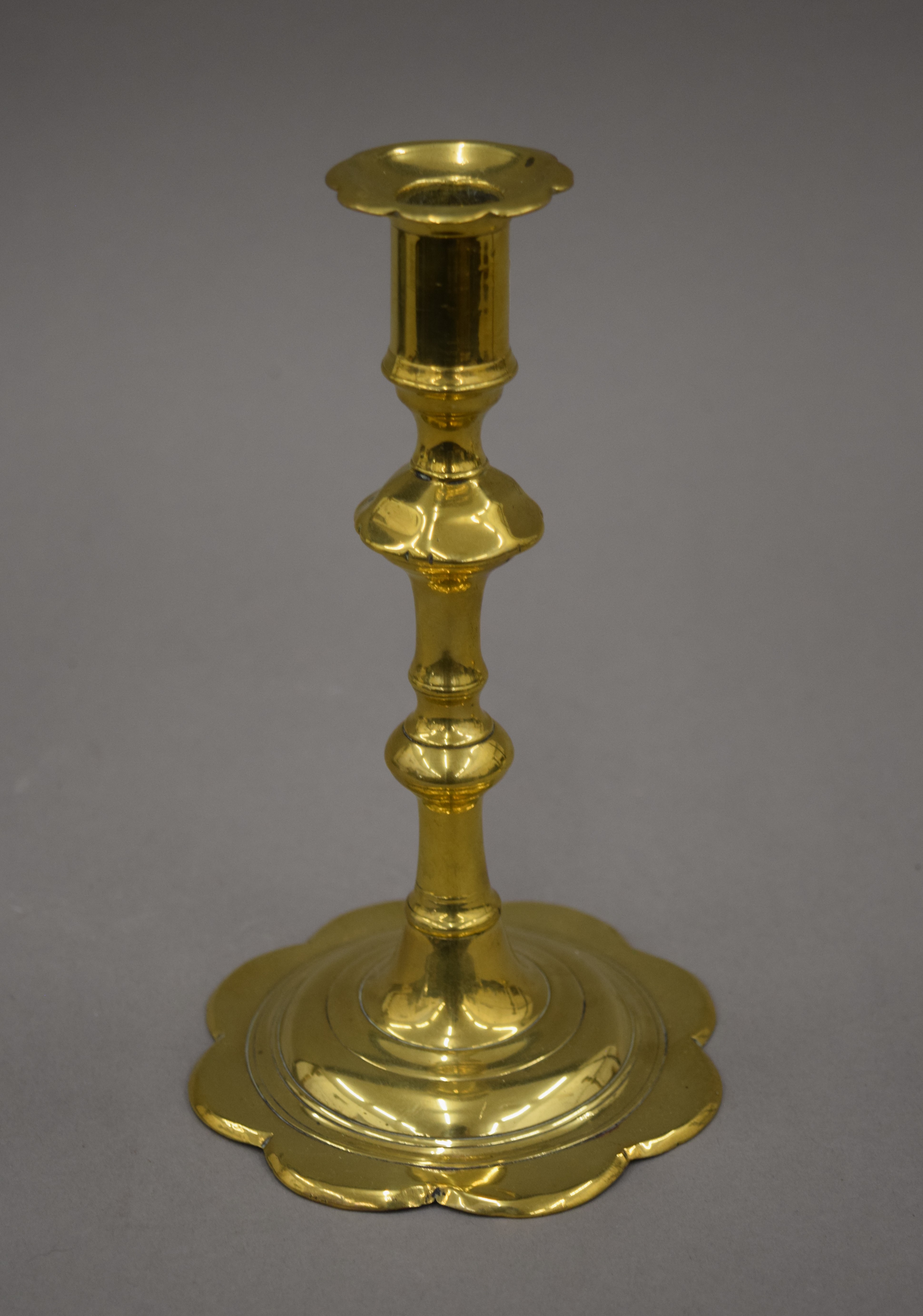 An 18th century brass candlestick with petal edge drip pan and base, - Image 2 of 9