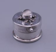 A small silver and moonstone patch box. 1.8 cm diameter.