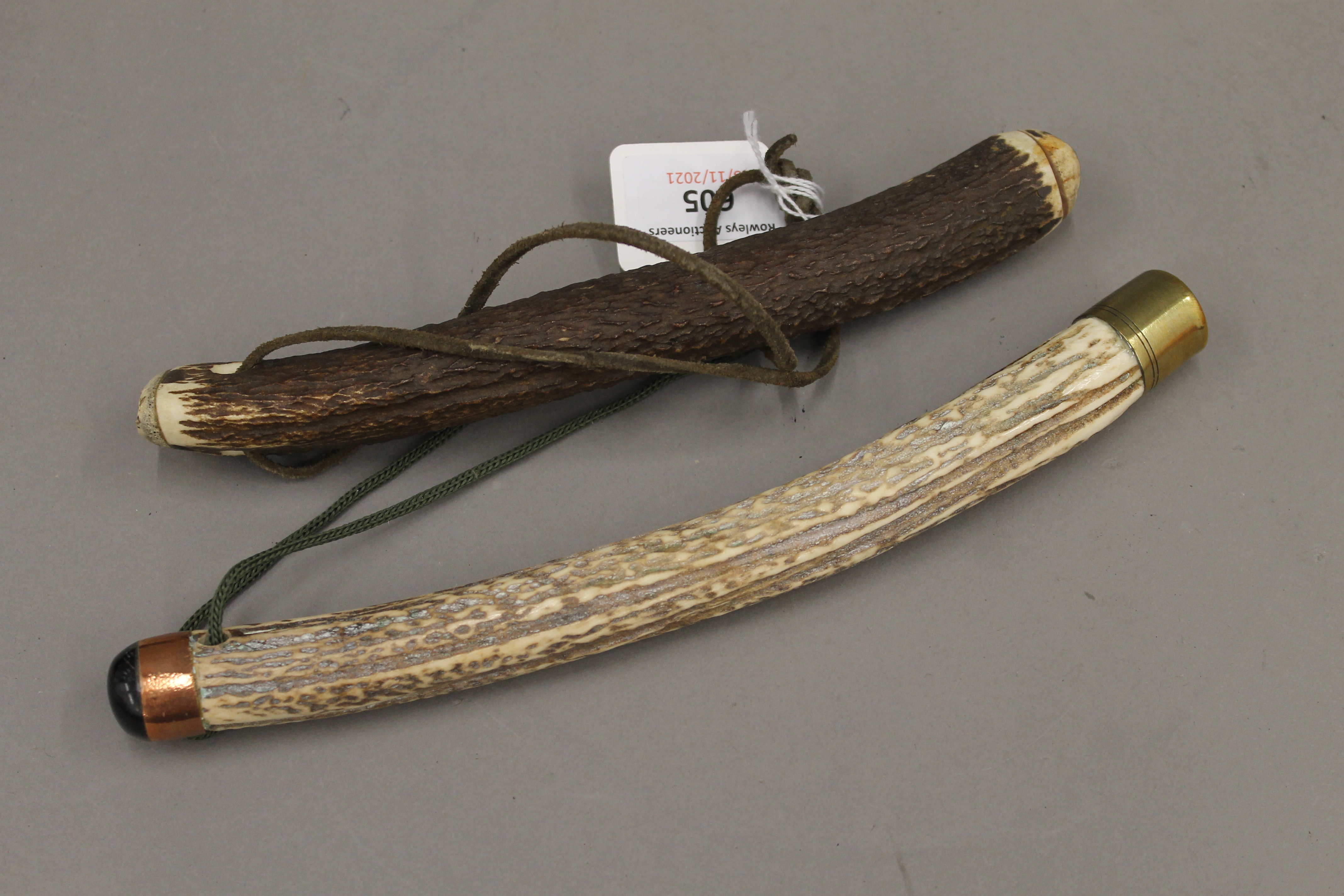Two stag horn fishing priests. The largest 25 cm long.