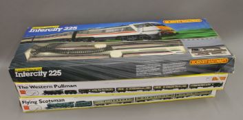 Three boxed Hornby railway sets.