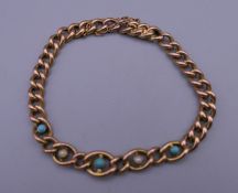 A 9 ct gold turquoise and seed pearl set bracelet. 18 cm long. 10 grammes total weight.