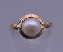 A 9 ct gold pearl set ring. Ring size P. 1.8 grammes total weight.