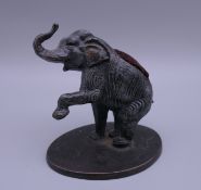 A cold painted bronze elephant form pin cushion. 7.5 cm high.