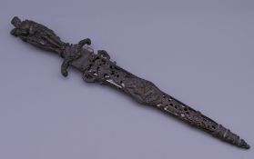 A Continental dagger with cast bronze handle and scabbard. 30 cm long.