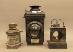 Three vintage lamps including a LMS lamp and a small copper Masthead lamp. The largest 38 cm high.