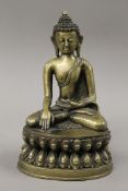 A brass figure of a seated Buddha. 24 cm high.