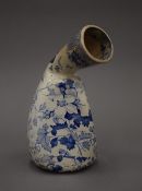 A 19th century blue and white transfer printed pottery bourdaloue (gentleman's urinal). 21 cm long.