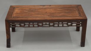 A Chinese carved hardwood low table. 86 cm long.
