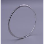 A Contemporary silver bangle. 7 cm diameter.