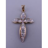 A 9 ct gold stone set cross pendant. 5 cm high. 5.8 grammes total weight.