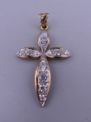 A 9 ct gold stone set cross pendant. 5 cm high. 5.8 grammes total weight.