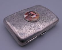 A silver cigarette case depicting a girl. 6 cm wide.