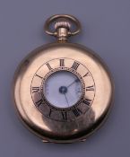 A 9 ct gold Waltham half hunter pocket watch. 5 cm diameter. 94 grammes total weight.