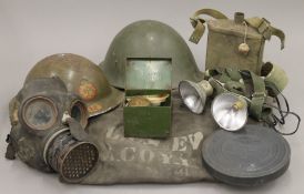 A quantity of various militaria, including helmets, gas mask and a reel of War Department film.