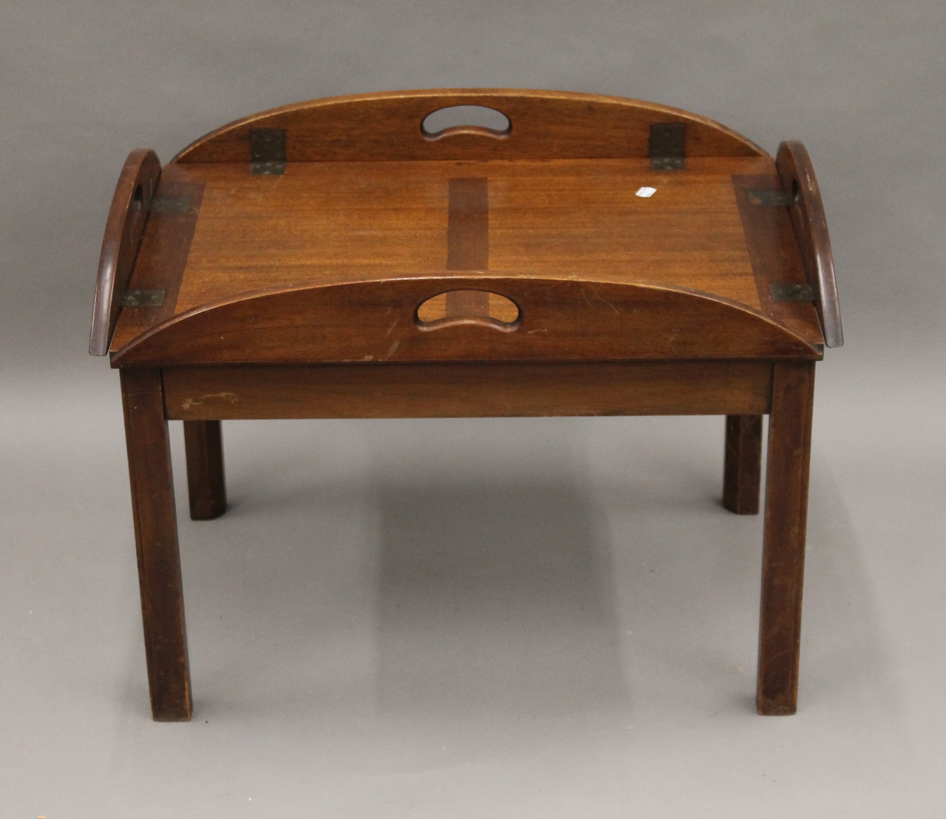 A mahogany butlers tray type coffee table. 86 cm long with flaps down.