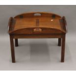 A mahogany butlers tray type coffee table. 86 cm long with flaps down.