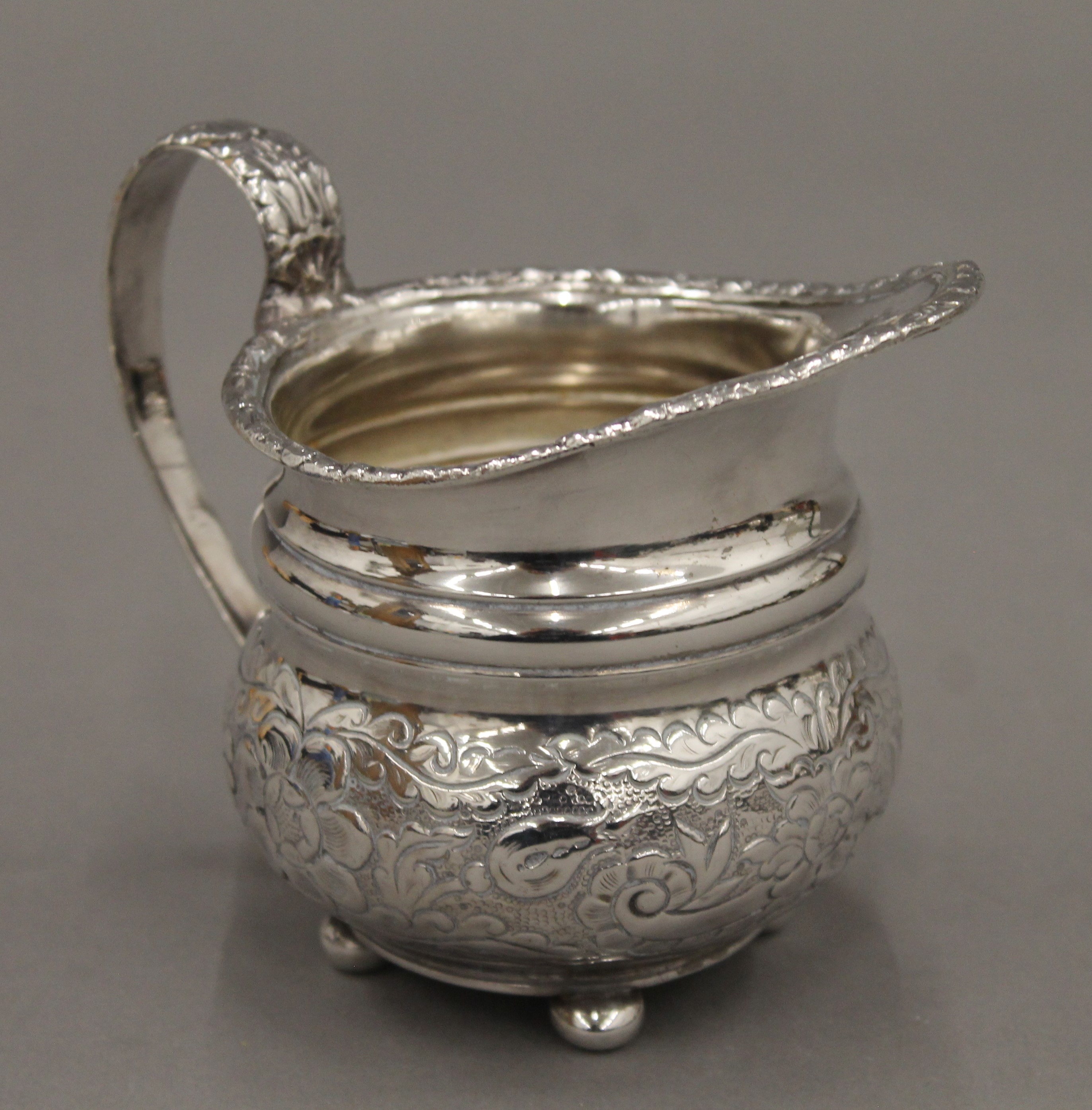 A Victorian three-piece ornate silver plated tea set and a tray. - Image 3 of 4