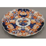 A 19th century Japanese porcelain scallop edged Imari dish. 38 cm diameter.