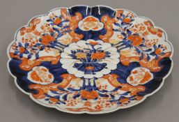 A 19th century Japanese porcelain scallop edged Imari dish. 38 cm diameter.