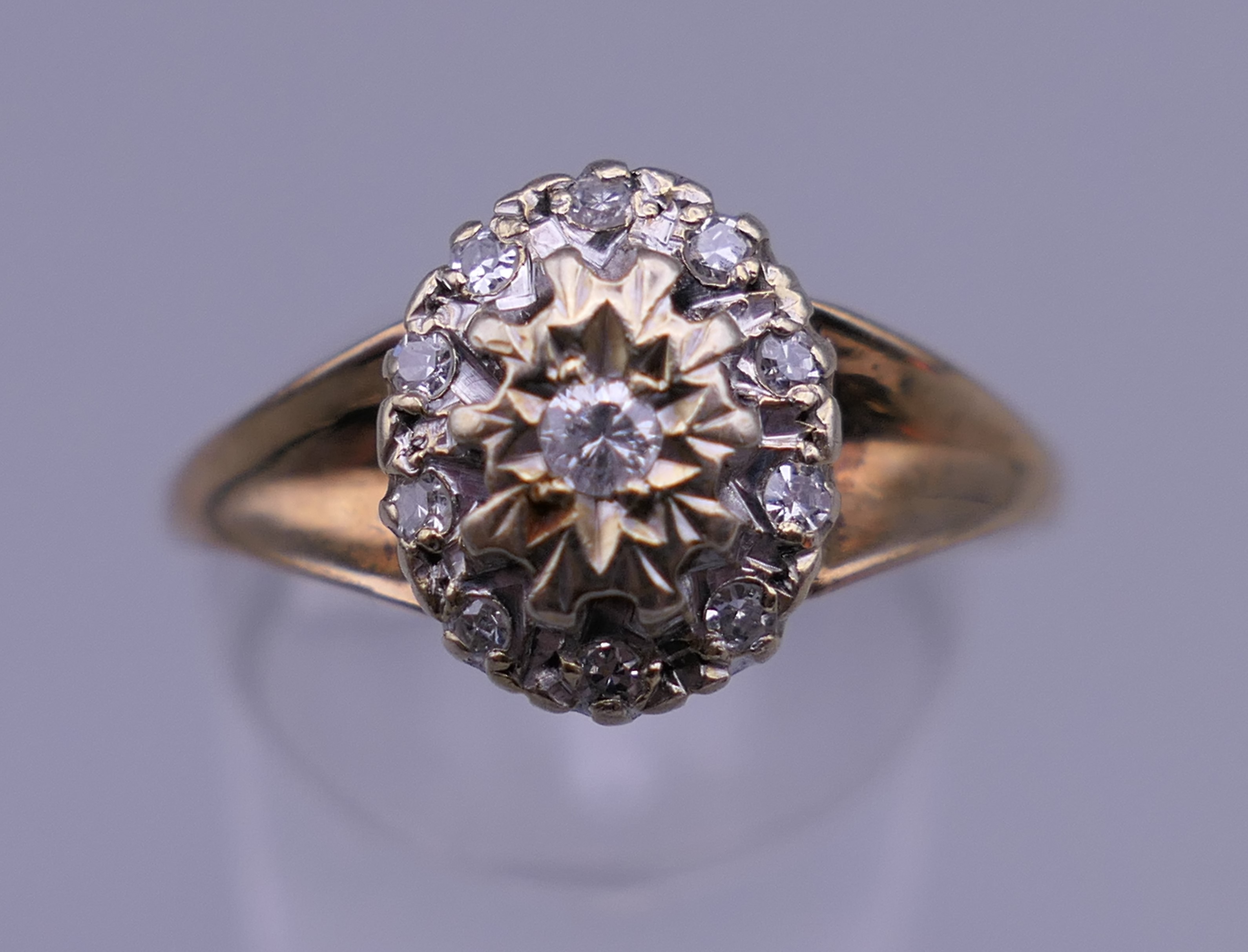 A 9 ct gold diamond cluster ring. Ring size S/T. 3 grammes total weight.