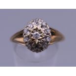 A 9 ct gold diamond cluster ring. Ring size S/T. 3 grammes total weight.