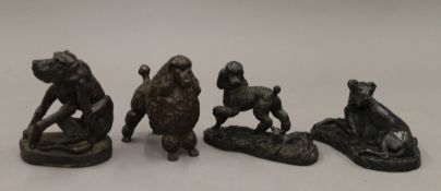 Four bronzed dog ornaments. The largest 11.5 cm high.