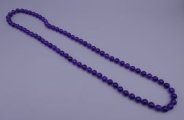 A string of lavender jade beads. 69 cm long.